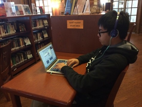 Student Minh Nguyen studies quietly in the library.