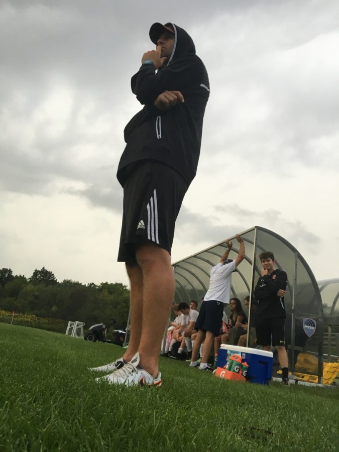 Coach Makovec seems analyzes the style of soccer his team is playing.