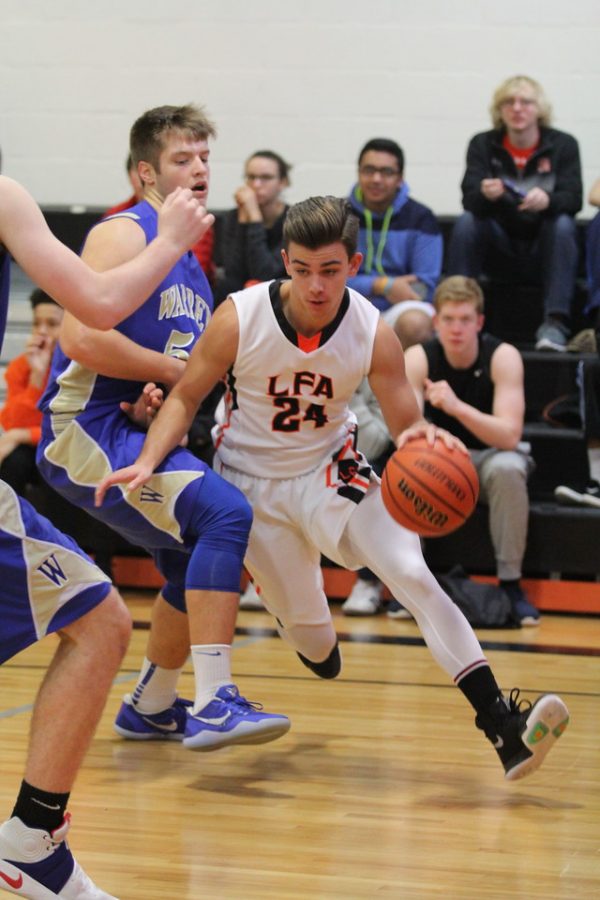 Sophomore Paul Podedworny drives to the basket against Warren. 
