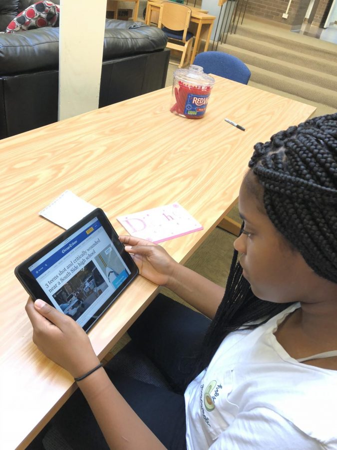 Freshman, Safiya Nicol, is reading a Chicago Tribune article about the shooting of three teens in Chicago’s South Side.