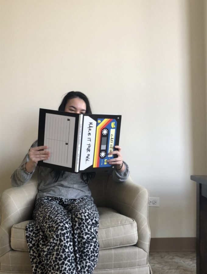Gigi+Taillon+reads+the+2019-2020+yearbook.