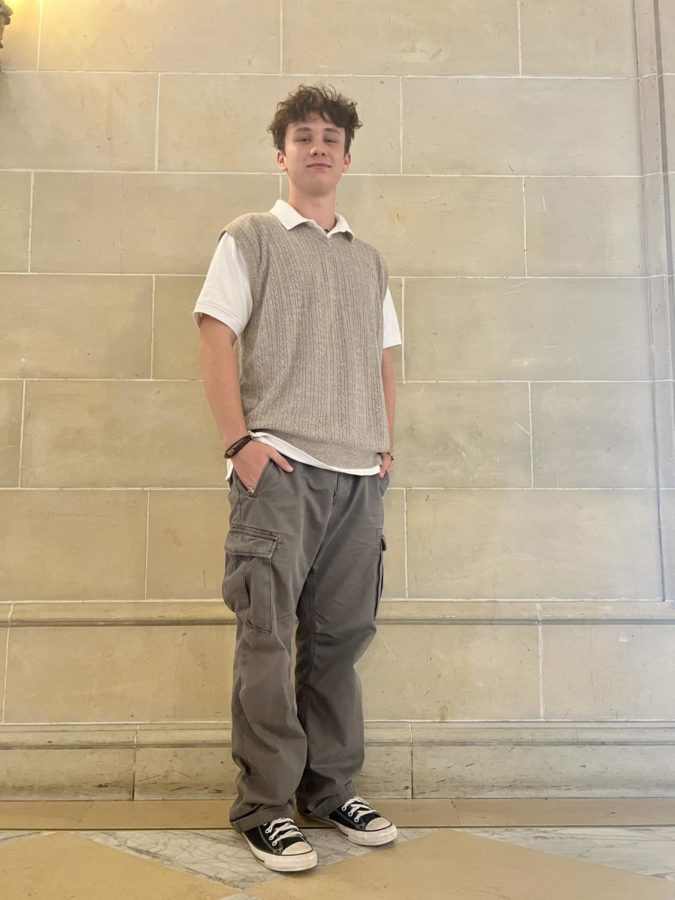 Teagan Hubbard ‘24 wears his outfit of all thrifted items: shirt and vest, grey cargo pants, and jewelry and shoes.