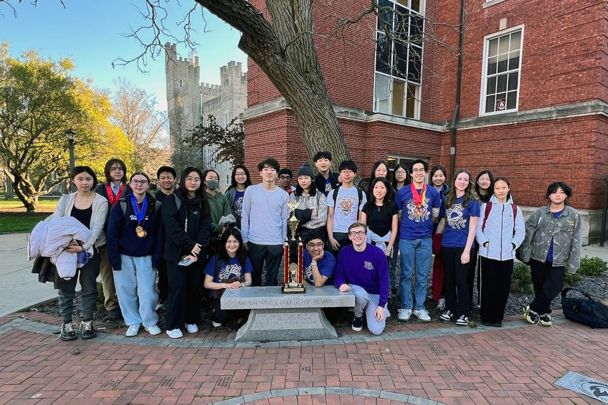 The Math Team poses together with their first-place state championship trophy at Illinois State University. 